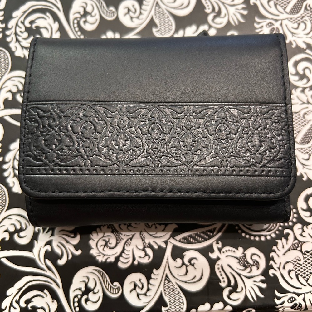 Liz Claiborne tri-fold wallet. Black with imbedded design.